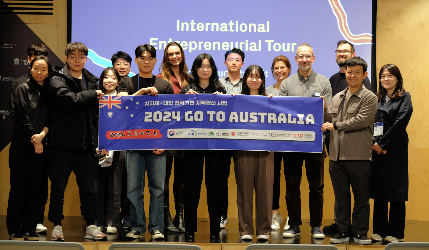 Korean students holding a banner showcasing their trip to Australia in 2024 