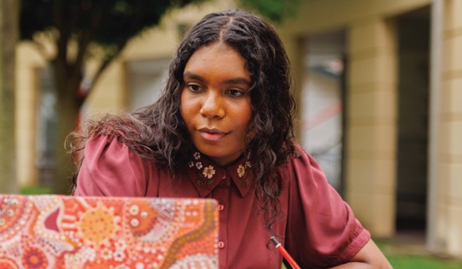 Photo of an Aboriginal girl looking at a laptop