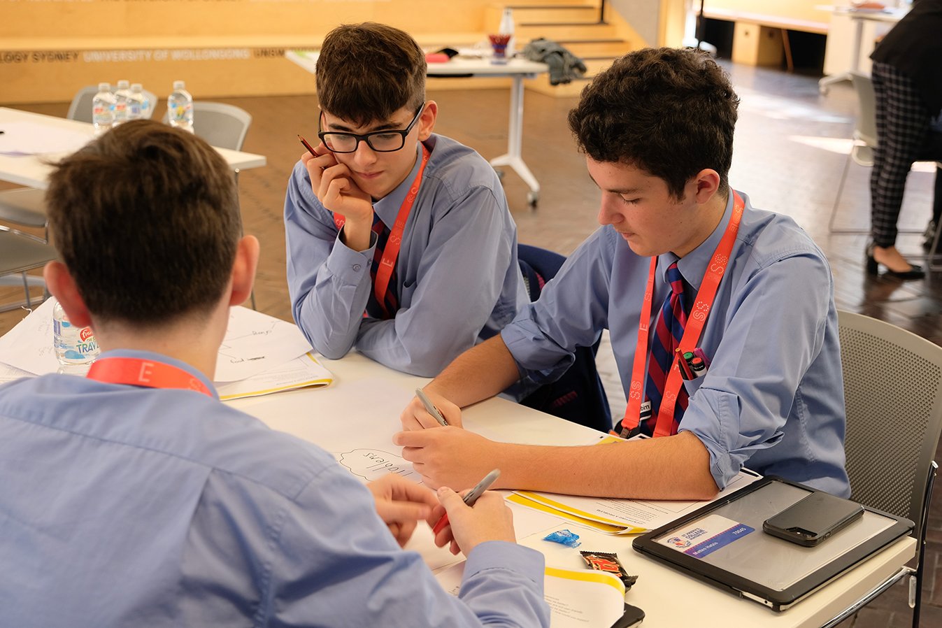Teenage school boys around a table in a workshop